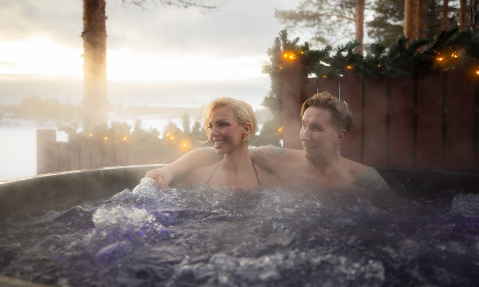 Beautiful evening by the Kemijoki river in hot tub. | Aino Private Island Hotel