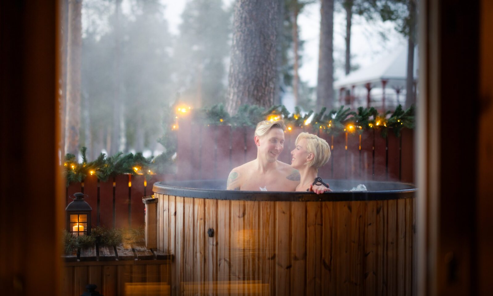 Couple in hot tub, winter setting.