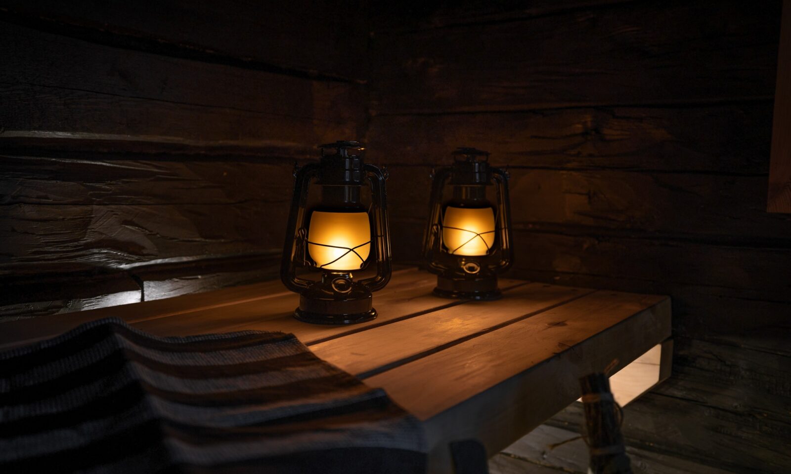 Two lanterns on wooden table