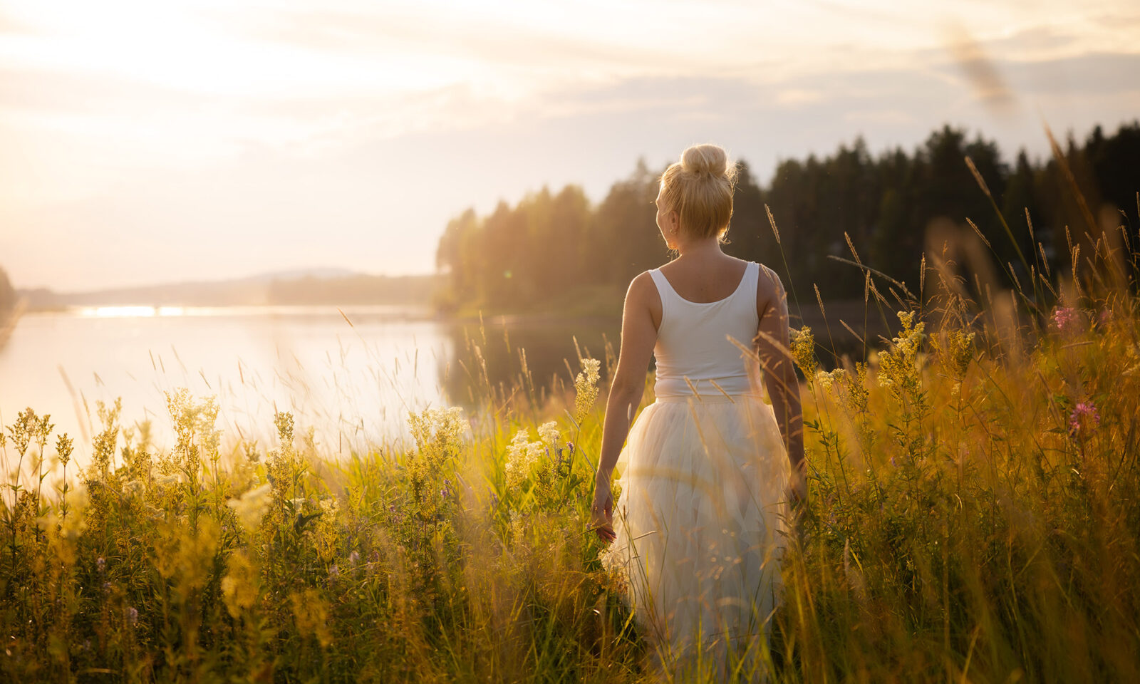 Woman walking in summer night at Aino Private Island Hotel.
