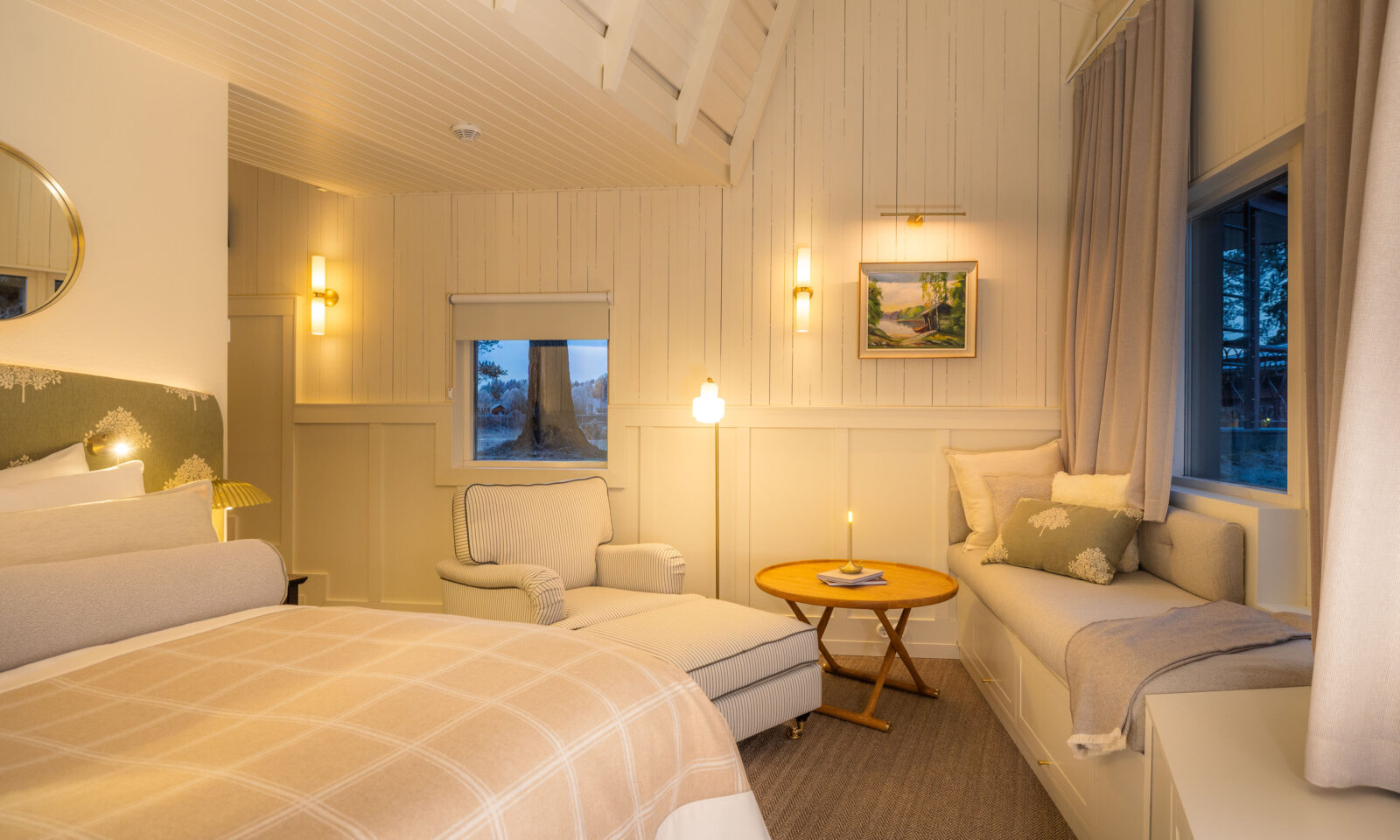 Aino's suite interior with double bed and reading nook.