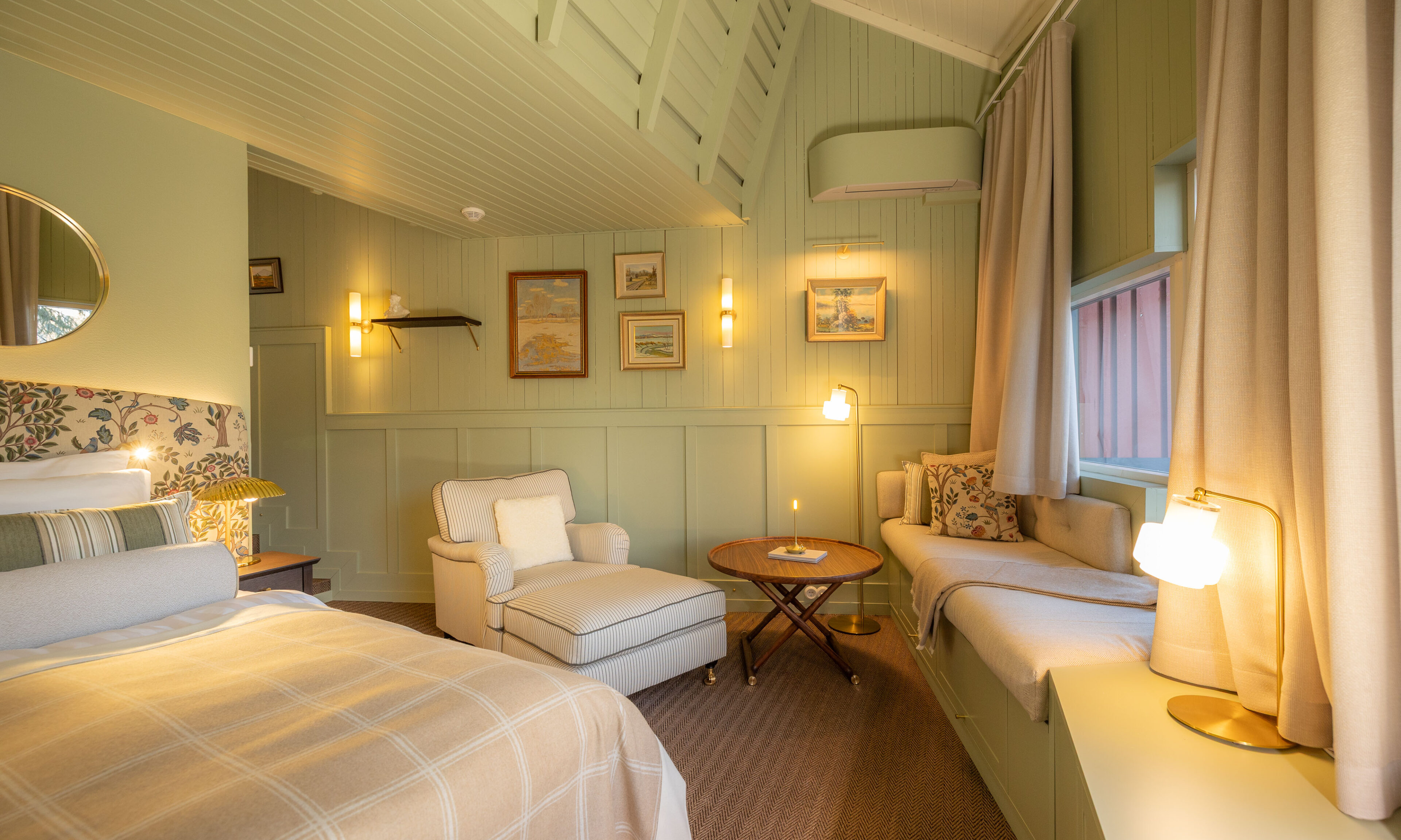 Green-themed river suite with loft at Aino Private Island Hotel, Rovaniemi, Lapland.