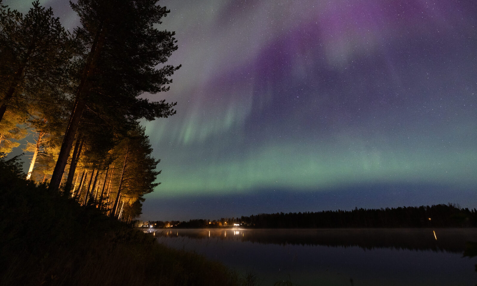 Northern Lights dancing above Aino Private Island Hotel, Rovaniemi, Lapland.