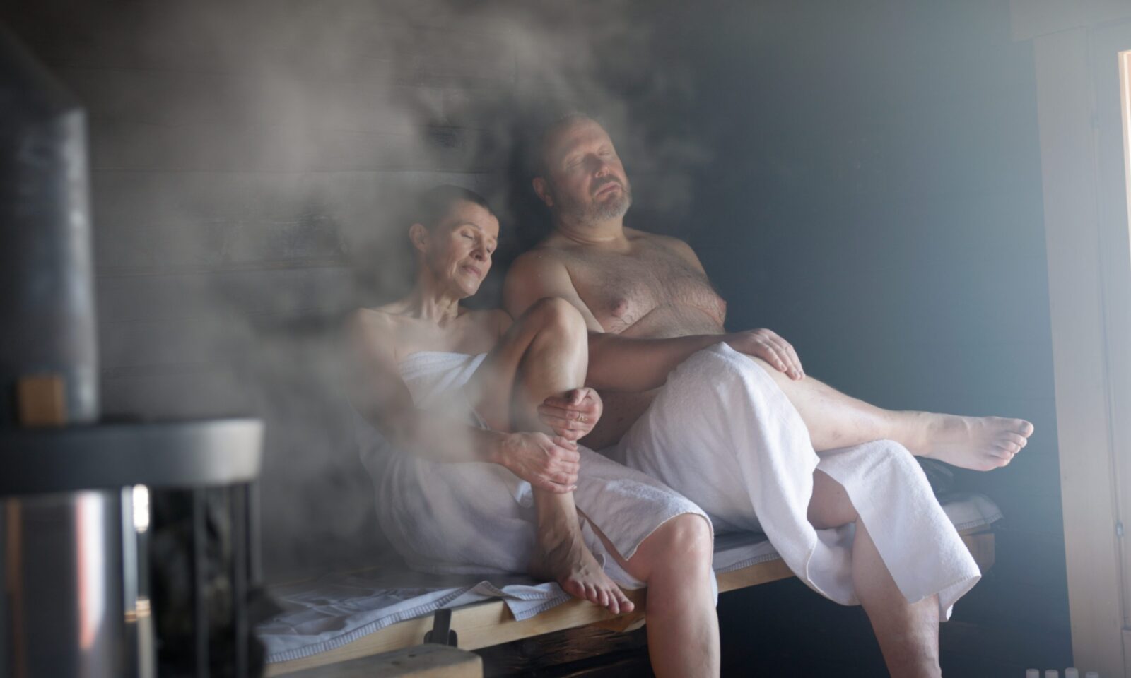 Couple enjoying traditional Finnish sauna in Aino Private Island Hotel.