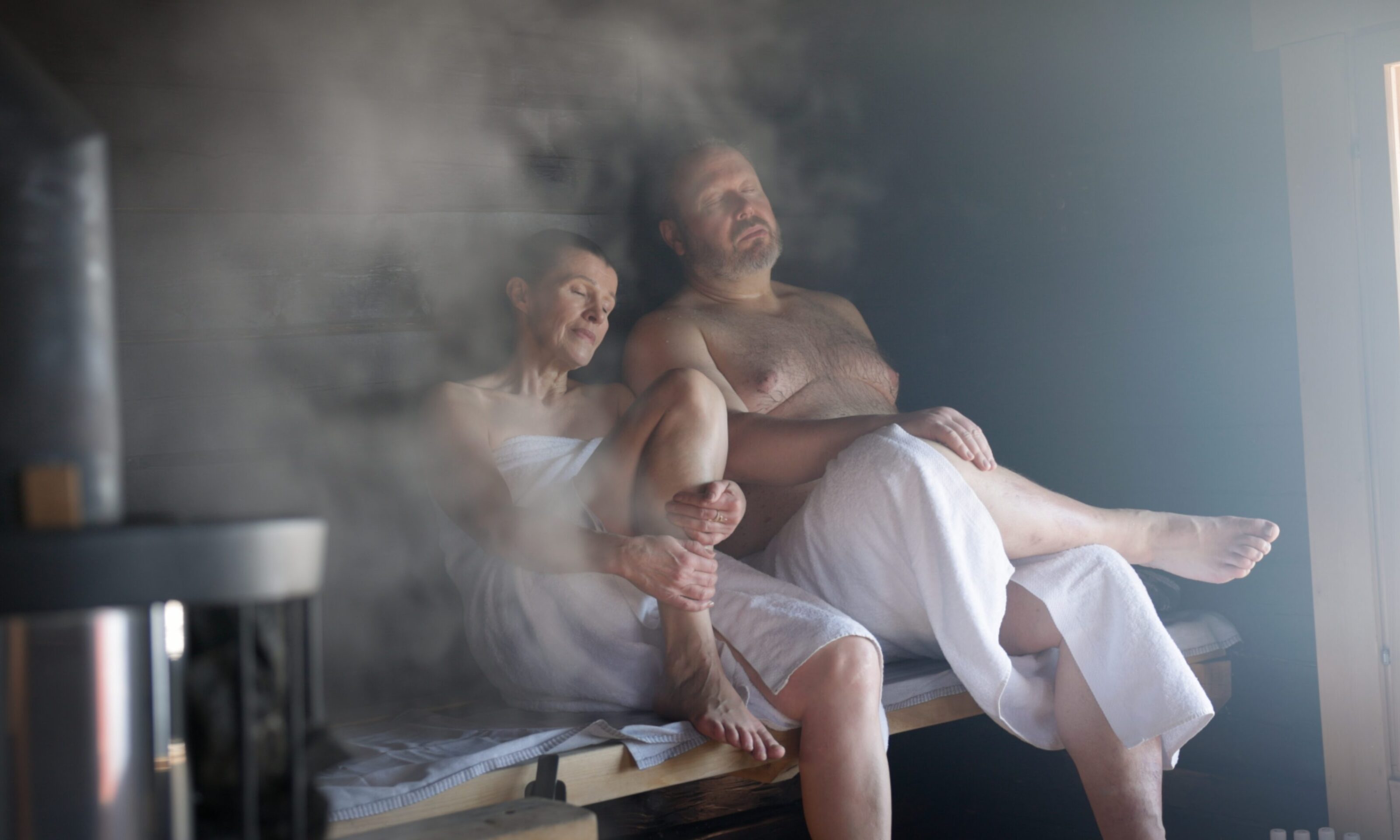 Couple enjoying traditional Finnish sauna in Aino Private Island Hotel.