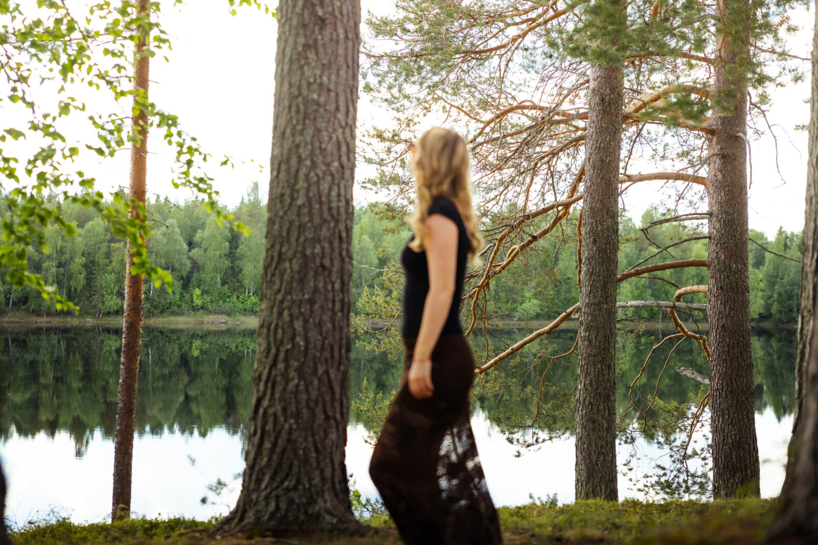 Woman walking on the shore of Aino Private Island.