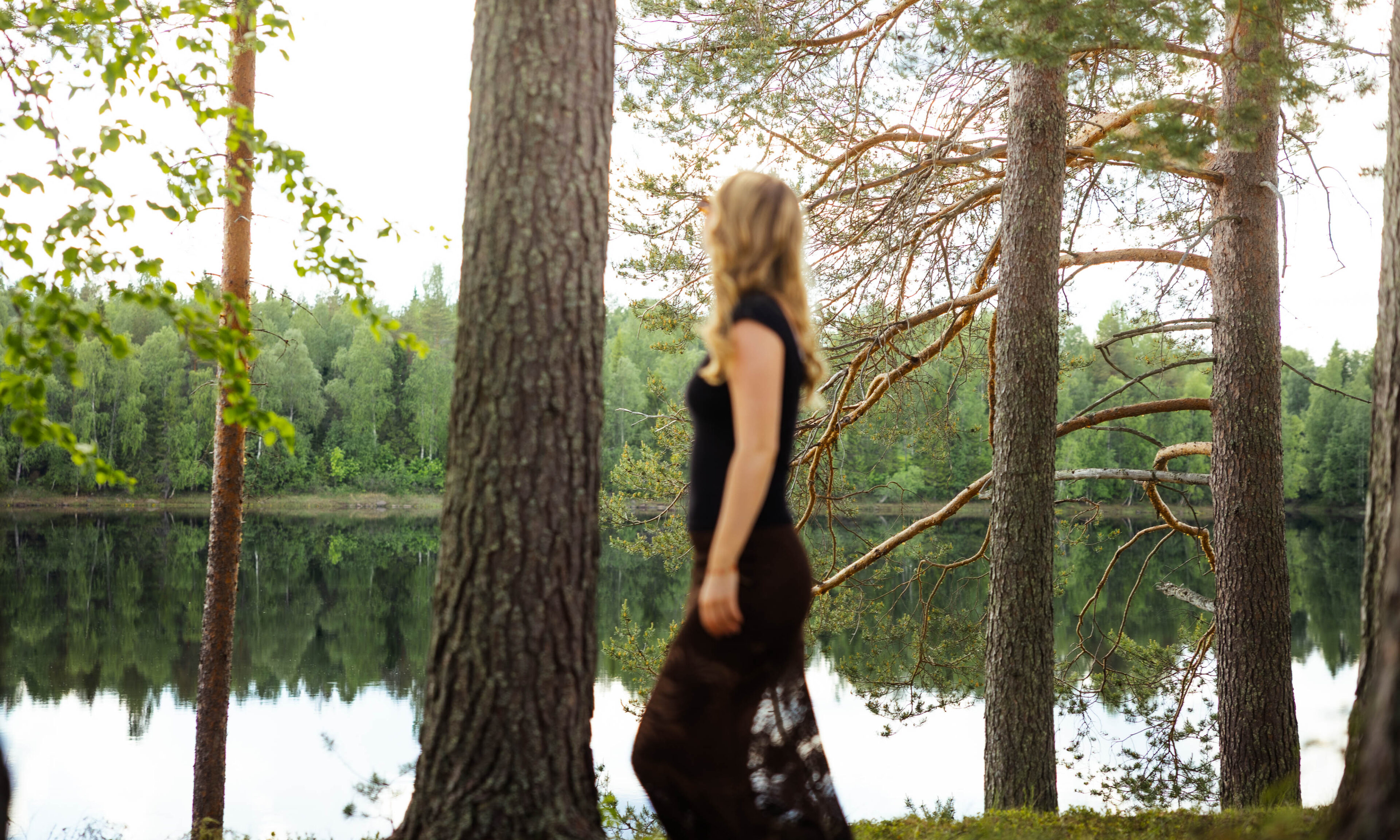 Woman walking on the shore of Aino Private Island.