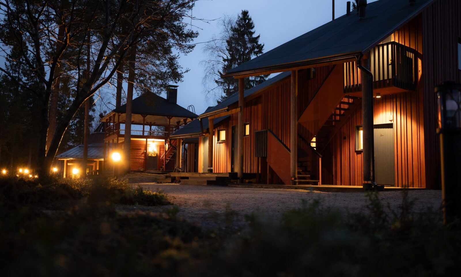 Nordic wooden architecture at Aino Private Island in the evening.